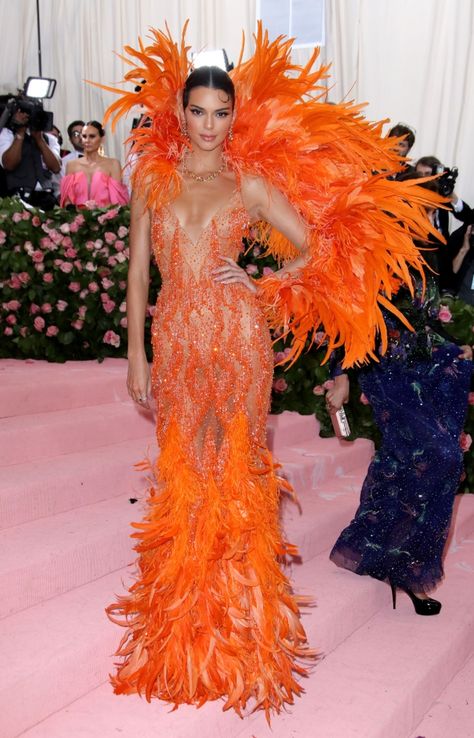 Met Gala 2019: Kendall & Kylie Jenner Walk Red Carpet in Versace – Footwear News Kylie Jenner Met Gala, Kendall Jenner Met, Kendall Jenner Met Gala, Orange Gown, Off Shoulder Ball Gown, Orange Prom Dresses, Met Gala Outfits, Versace Gown, Met Gala Dresses