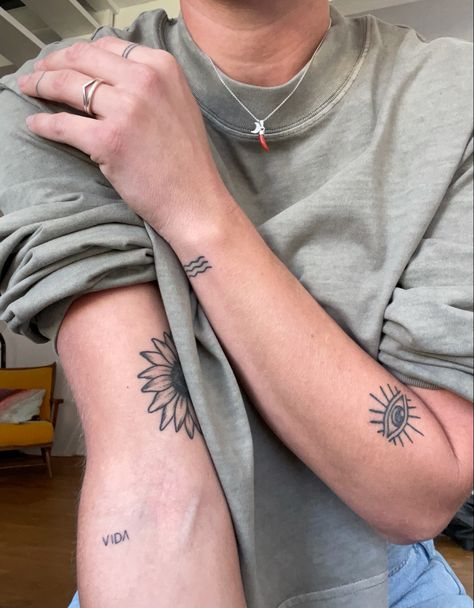 Arm tattoos, eye, sunflower, beach, vida, finger tattoos Symmetrical Arm Tattoos, Behind The Arm Tattoo, Tattoo Placement Arm, Medium Size Tattoos, Arm Tats, Good Luck Spells, Flabby Arms, Luck Spells, Upper Arm Tattoos