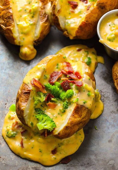 The baked potatoes get sliced in half, baked in the oven and topped with a loaded bacon broccoli cheddar sauce. A super, easy family favorite dish on your table in 30 minutes. Loaded Broccoli, Broccoli Bacon, Baked Potato Bar, Stuffed Baked Potatoes, Homemade Cheese Sauce, Potato Bar, Cheese Sauce Recipe, Baked Potato Recipes, Loaded Potato