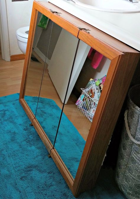 How to repurpose an old medicine cabinet Upcycled Medicine Cabinet, Trifold Mirror Medicine Cabinet, Diy Old Medicine Cabinet Makeover, Medicine Cabinet Repurpose, Redo Medicine Cabinet Diy, Medicine Cabinet Alternatives, Medicine Cabinet Door Makeover, Oak Medicine Cabinet Makeover, Upcycle Medicine Cabinet