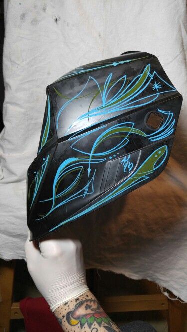 Free hand pinstriping on a welding helmet. If you are interested in any custom art work similar to this or any style please contact me at knucklehed7@gmail.com. You can also check out my work at www.Facebook.com/knucklehedkustomartanddesign Welding Hood Designs, Welding Helmet Art, Custom Welding Hoods, Bad Wolf Tattoo, Welding Women, Custom Welding Helmets, Painted Welding Helmet, Monster Cans Diy, Welding Helmet Designs