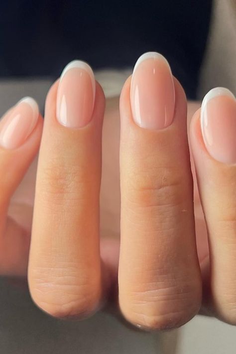 Timeless elegance in a manicure! The nails are crafted with a soft almond shape, featuring a classic French tip that's flawlessly executed with crisp white borders. The nude base complements the white perfectly, creating a sleek and sophisticated look suitable for any occasion. Perfect for those who appreciate a chic, refined style.  // Photo Credit: Instagram @nailhousebydiana Classic Short Almond Nails, Classic Squoval Nails, French Nails Ideas Oval, French Tip Gel Manicure Natural Nails, Clear Wedding Nails, French American Nails Natural, Neutral Color French Tip Nails, Manicure Ideas Almond Shape, Short Almond French Manicure