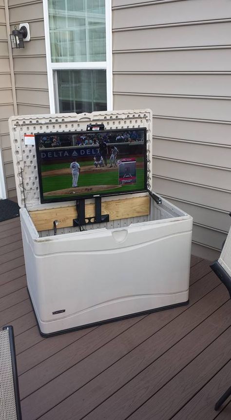 I wanted a TV on the deck. Converted a deck box to hold the TV and used a swing away TV mount turned on its side to fold the TV down into the deck box when not in use and to protect from the weather. Used a 2x6 board lag bolted from behind the box to support the TV mount Deck Tv Outdoor Tv Cabinet, Small Patio Tv Ideas, Covered Deck Tv Ideas, Tv On Back Porch, Garage Tv Mount, Diy Outdoor Tv Stand Ideas, Small Backyard Tv Ideas Patio, Tv Outside Patio Outdoor Tv Cabinet, Outdoor Tv On Deck