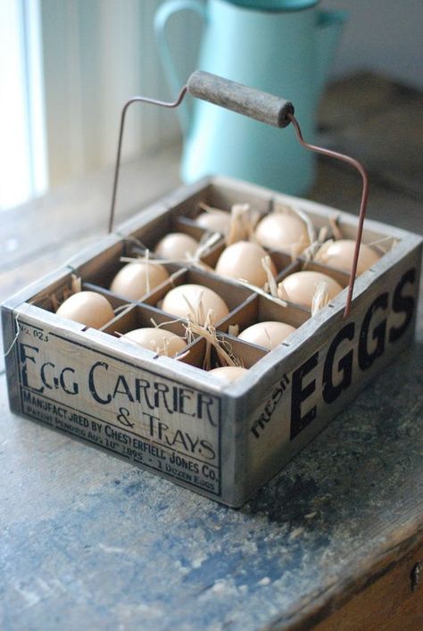 the wooden egg crate features a vintage style company logo, wire handle, and one dozen plastic eggs nestled in straw Egg Carrier, Plastic Crate, Easter Entertaining, Crate Diy, Plastic Crates, Wood Eggs, Egg Crates, Primitive Kitchen, Plastic Eggs