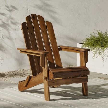 Relax in your backyard when you purchase one or more of these Adirondack folding chairs by Walker Edison. Create the perfect reading nook by placing this laid-back seat underneath a tree. Set several around a campfire for summer vacation vibes. Or gather friends and family together on the patio for great conversation when you use several of these patio chairs. The solid acacia wood build ensures these outdoor chairs will be a staple in your backyard for years to come. Available in several colors Deck Fire Pit, Adirondack Chairs Patio, Wood Adirondack Chairs, Folding Adirondack Chairs, Large Chair, Walker Edison, Vacation Vibes, Folding Chairs, Decks And Porches