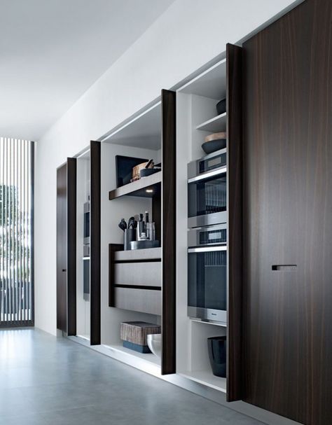 It makes so much sense when space is tight: kitchens concealed behind accordion doors, sliding doors, cabinet doors—anything it takes to keep the clutter out of sight. Modern Konyhatervezés, Hidden Kitchen, Design Del Prodotto, Wooden Kitchen, Pocket Doors, Interior Inspo, Contemporary Kitchen, 인테리어 디자인, Modern Kitchen Design