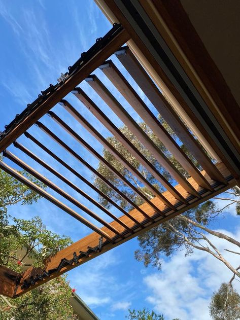 My DIY adjustable timber louvred pergola. Used the FLEXfence louvre system product. Purchased from Timberblindsexpress in AU. Each set allows 11 louvres up to 1.2m (I used 135x19 spotted gum decking) and is adjustable manually. I may add link each set for adjustment without a ladder. The system is for shade & does not block out the rain. Very happy with the result & it was very affordable for a premium look & DIY effort. Graham Davies, Frankston VIC Louvred Pergola, Spotted Gum Decking, Louvered Pergola, Pergola Attached To House, A Ladder, Deck Ideas, I Said, The Rain, Blinds