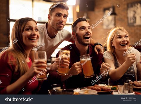 Group of cheerful friends having fun while watching sports game on TV and drinking beer in a bar.  royalty free images photo Watching Friends, Bar Ad, Friends Having Fun, Beer Cheers, Beer Party, Fun Group, Friends Group, Industrial Photography, Sports Game