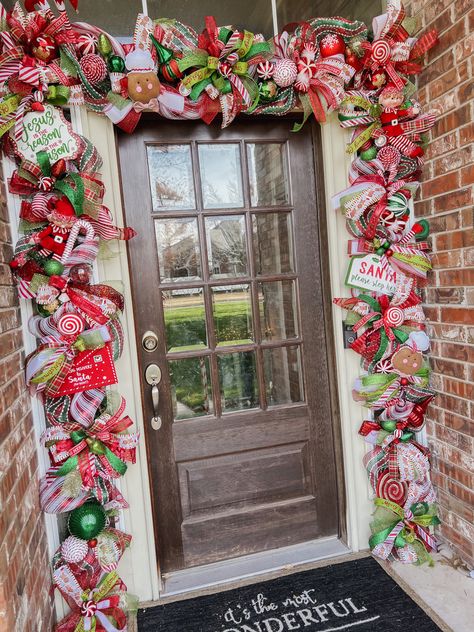 Christmas door garland made from deco mesh and multiple width wired ribbons. Ornaments & decorative bobbles secured on as well. Attached to pre-lit faux green garland. Colors are mainly red, green, grinch green, and white with Gingerbread and Candy Canes as the main theme. Candy Cane Stair Garland, Whimsical Garland Christmas, Candy Cane Christmas Garland, Gingerbread Christmas Decor Wreaths & Garlands, Candy Cane Garland Christmas Decor, Gingerbread Christmas Garland, Gingerbread Garland Ideas, Garland Doorway Christmas, Christmas Door Garland Ideas