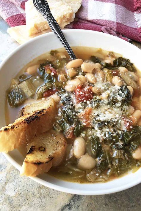 Quick, easy, and inexpensive, beans and greens soup is an Italian-style recipe with comforting and hearty ingredients. You'll love each spoonful of creamy beans, tender escarole, and seasoned broth. Read more now. #italianrecipes #beansoup #foodal Pantry Staple Meals, Frugal Pantry, Escarole Recipes, Staple Meals, Creamy Beans, Escarole Soup, Greens Soup, Beans And Greens, Pantry Meals