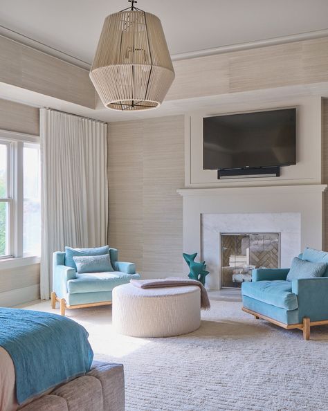 Bedroom sitting area with bright blue lounge chairs, fireplace, and tv Chair Under Tv, Chairs Fireplace, Sitting Area Design, Bedroom Sitting Area, Fireplace And Tv, Blue Lounge Chair, Bedroom Inspiration Cozy, Cozy Sitting Area, Bedroom Sitting