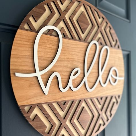 Say hello with this cool geometric door hanger. Layers of maple, cherry and walnut with white lettering. 18" Round disc with 1/4" laser cut wood layers. We recommend hanging with velcro picture hanging strips (not included). Contact us with special requests! Laser Wood Projects, Wood Laser Cut Ideas, Crafts For Family, Ideas For Christmas Cards, Wood Crafts For Kids, Wood Crafts Ideas, Laser Cut Ideas, Geometric Door, Diy Laser Cut