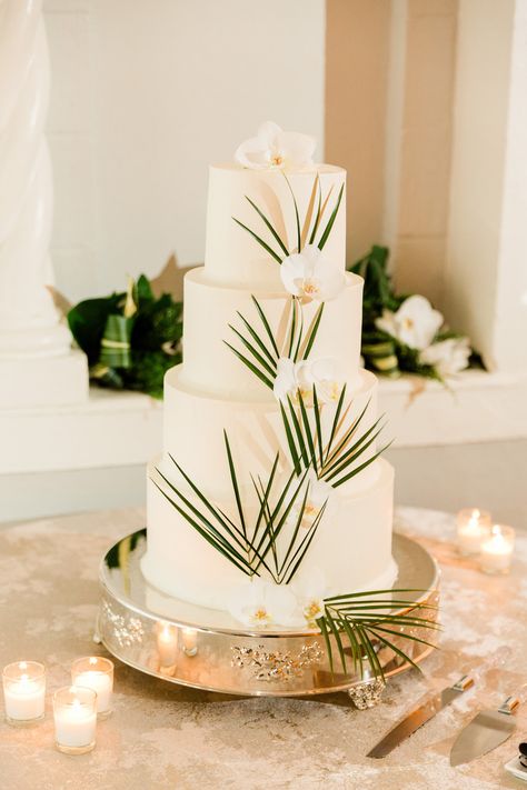 Modern, Smooth White Four Tier Wedding Cake with Dark Green Palm Leaves, White Orchid Flower, Silver Cake Stand | The Vinoy Renaissance St. Petersburg Resort & Golf Club | Luxury Florida Wedding Planner Parties A'La Carte Wedding Cake With Palm Leaves, Palm Wedding Cake, Tropic Cake, Cake Wedding Elegant, Palm Leaves Cake, Palm Leaves Wedding, Tropical Wedding Cake, Silver Cake Stand, St Pete Wedding