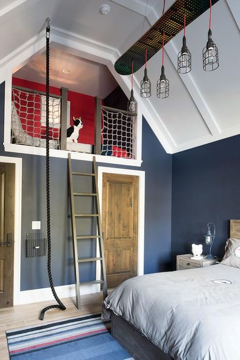 Blue and red boy's bedroom boasts a blue striped rug placed in front of a wood bed dressed in gray bedding lit by linear cage chandelier hung from a white panel vaulted ceiling. Turquoise Teen Bedroom, Red Boys Bedroom, Vaulted Ceiling Bedroom, Boys Room Blue, Magical Furniture, Teen Bedroom Designs, Teen Boy Bedroom, Blue Furniture, Bedroom Photos