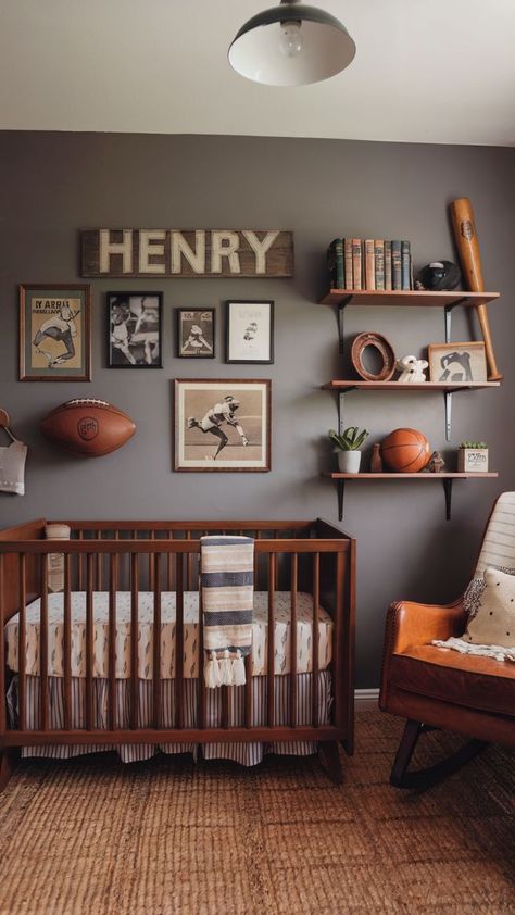 Warm-toned nursery featuring a vintage sports theme with wooden crib, leather rocking chair, and framed sports memorabilia. Grandpa Study Nursery, Sports Nursery Theme Vintage, Sports Themed Rooms For Boys, Baby Boy Sports Nursery Room Ideas, Ski Nursery Theme, Nursery Ideas Baseball, Antique Sports Nursery, Retro Sports Nursery, Polo Ralph Lauren Nursery