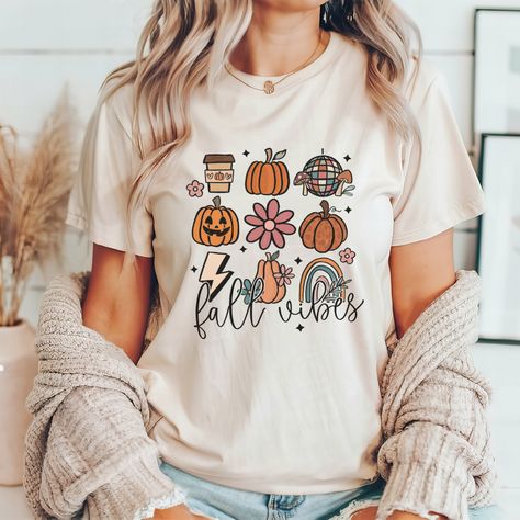 Embrace the beauty of autumn with our charming fall teacher tee! Perfect for the classroom or casual outings, this shirt captures the warm, cozy vibes of the season while celebrating your passion for teaching. This classic unisex jersey short sleeve tee fits like a well-loved favorite. Soft cotton and quality print make users fall in love with it over and over again. These t-shirts have-ribbed knit collars to bolster shaping. The shoulders have taping for better fit over time. Dual side seams ho Teacher Thanksgiving Shirts, Fall Teacher Shirts, Teachers Thanksgiving, Cute Shirt Designs, Teacher Tees, Teacher Ideas, Cozy Vibes, Thanksgiving Shirts, Teacher Tshirts