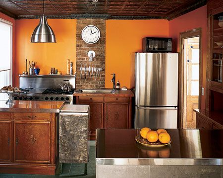 Love the orange of the walls and the exposed brick. #kitchen Burnt Orange Kitchen, Orange Kitchen Walls, Orange Kitchen Decor, Interior Paint Colors Schemes, Craftsman Bungalow, Space Saving Kitchen, Kitchen Colour Schemes, Orange Kitchen, Kitchen Paint Colors