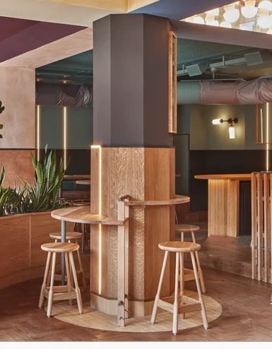 Retail Store Seating Area, Restaurant Column Design, Interior Pillars, Herringbone Wooden Floors, Purple Ceiling, Bank Interior, Circular Ceiling Light, Amsterdam Cafe, Folding Architecture