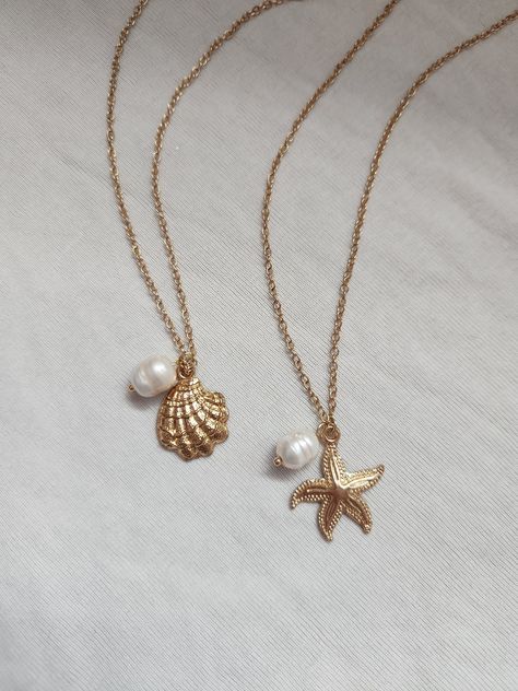 -seaside girl necklace- miss the ocean? bring a little of it with you with this coastal-themed necklace! seaside girl starfish necklace: features a starfish charm, freshwater pearl charm, gold chain, lobster clasp, and extension chain. details:  - 38 cm without extension  - 43 cm with extension  - comfortable & durable  - handmade with love seaside girl shell necklace: features a shell charm, freshwater pearl charm, gold chain, lobster clasp, and extension chain. details:  - 38 cm without extension  - 43 cm with extension  - comfortable & durable  - handmade with love feel free to message me if you have any questions or concerns! Shell With Pearl Necklace, Shell Gold Necklace, Necklaces With Charms, Beach Themed Jewelry, Sea Shells Necklace, Beach Jewelry Aesthetic, Dope Jewelry Accessories, Coastal Jewelry, Surf Jewelry