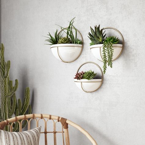 This trio of glossy white planters will add depth and interest to any modern space. Each planter is in a half-moon shape and set in a gold metal frame. Crafted entirely out of metal, they're a chic piece that work with industrial, mid-century modern, or eclectic styles. Place your favorite faux plants or succulents inside then hang with ease. Size: 13"H x 13"W x6.5"D/11.5 x 11.5 x5.5/10.5 x 10.5 x5. Wall Plants, Planters Indoor, Decor Things, Metal Wall Planters, Wall Planters Indoor, Entry Ideas, Plant Mama, Wall Planters, Plant Wall Decor