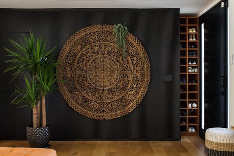 Black Feature Wall With Carved Balinese Panel and House Plant Hotels In Los Angeles, Bali Decor, Tropical Retreat, Balinese Decor, Black Feature Wall, Asian Interior, Bamboo Fence, Tropical Escape, Bali Fashion