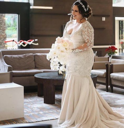 This long sleeve plus size bridal gown has a flattering open neck line. The fittedbodice flares into a flowing train. The beading on the #pretty lace is #nice. We are #USA dress #designers who make custom #plussizeweddingdresses for all shapes & sizes. Brides can also request #replicas of couture designer #dresses too. So if your #favorite design is way too expensive for your #budget we can help with a less expensive #inspired version for you. Email for pricing on custom #weddingdresses. Elegant Plus Size Dresses Wedding, Wedding Hairstyles For Plus Size Brides, Plus Size Bridal Hairstyles, Plus Sixe Wedding Dress, Plus Size Wedding Dresses With Sleeves Couture Candy, Plus Size Wedding Hairstyles, Plus Sixe Wedding Dresses, Long Train Wedding Dress Plus Size, Long Sleeve Fit And Flare Wedding Dress Plus Size