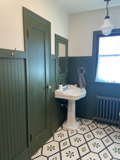 Green wainscoting, hexagon floor, petastal sink Blue Green Wainscotting, Green Wainscoting Kitchen, Green Wainscotting In Bathroom, Forest Green Wainscoting, Modern Bathroom Wainscotting, Green Panel Bathroom, Beadboard Half Wall Green, Dark Green Beadboard Bathroom, High Wainscoting Bathroom