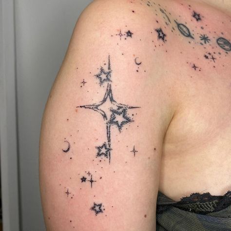 Star tattoo ideas symbolize guidance and dreams through celestial body art. These cosmic designs range from simple five-pointed stars to intricate constellations. Popular star tattoo concepts include shooting stars, star clusters, and zodiac symbols. Star ink styles vary from minimalist outlines to detailed, colorful pieces. Tattoos with stars can represent hope, ambition, and personal aspirations, often incorporating elements like moons or galaxies. Stipple Star Tattoo, Goth Star Tattoo, Small Star Face Tattoo, Purple Star Tattoo, 4 Pointed Star Tattoo, Whimsical Star Tattoo, Colorful Star Tattoos, Diamond Star Tattoo, Cool Star Tattoos