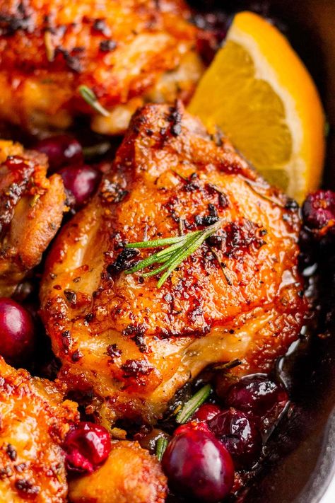 This cranberry chicken is chicken thighs roasted with fresh cranberries, orange juice and seasonings. A quick and easy dinner option that's great for a busy weeknight! Orange Cranberry Chicken Thighs, Baked Chicken Recipes Thanksgiving, Chicken Cranberry Wrap, Cranberry Roasted Chicken, Cranberry Orange Roasted Chicken, Apple & Cranberry Roasted Chicken, Chicken Christmas Dinner Ideas, Friendsgiving Chicken Recipes, Chicken Breast For Thanksgiving