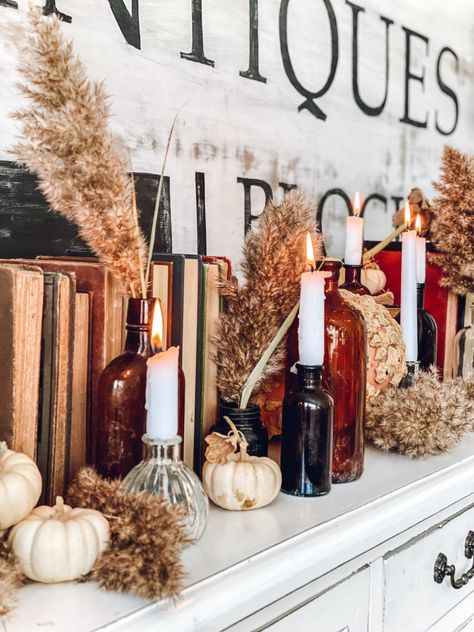 Fall decor & vintage bottles | LeCultivateur Restaurant Fall Decor, Vintage Fall Table Decor, Industrial Fall Decorations, Fall Decor Themes, Moody Fall Decor Home, Old Fashioned Fall Decor, Thrift Fall Decor, Fall Upcycle Decor, Fall Cabinet Decor