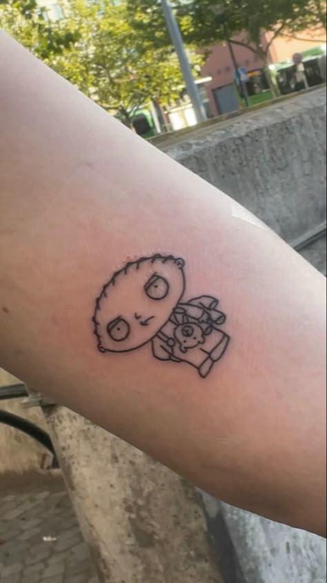 Stewie Griffin Tattoo Design, Family Guy Tattoo Design, Small Cartoon Tattoos For Men, Stewie Tattoo Ideas, Carton Tattoo Ideas, Family Guy Stewie Tattoo, Funny Cartoon Tattoos, Small Cartoon Tattoo Ideas, Stewie Griffin Tattoo