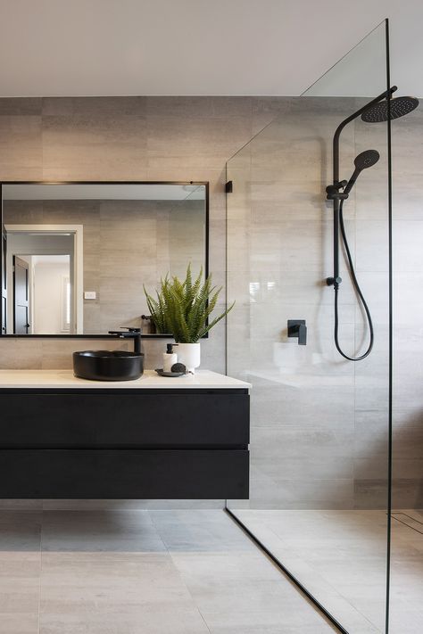 This bathroom and powder room are both stunning with grey tiles and matte black accents. The large windows allow for ample light to brighten up the space while maintaining the dark vibe. Dark Grey Tile Bathroom, Dark Vanity Bathroom, Moody Bathroom Ideas, Montgomery Homes, Moody Bathroom, Dark Gray Bathroom, Box Hill, Grey Bathroom Tiles, Black Floor Tiles