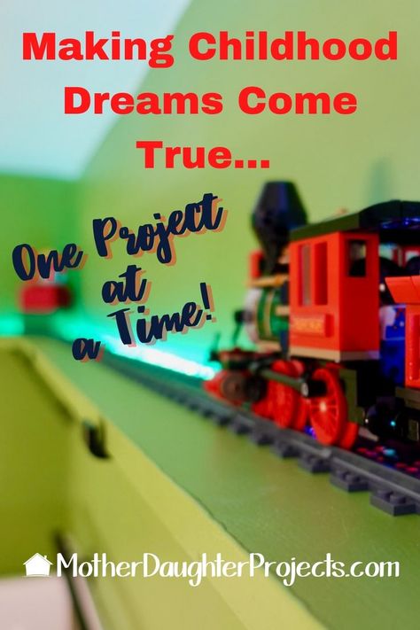 This LEGO travels high in the sky on this elevated wall hung train track. Thomas The Train Storage Ideas, Ceiling Train Track, Diy Train Tracks On Wall, Train Room For Boys, Wooden Train Track Storage, Train Shelf, Boys Train Room, Lego Track, Train Wall Art Kids Room