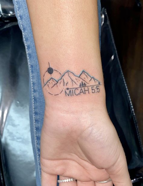 Small wrist tattoo with mountains and geographical patterns with bible verse Mountain Bible Verse Tattoo, Biblical Mountain Tattoo, Wrist Bible Verse Tattoo, Small Bird Tattoos For Women Arm, Christian Mountain Tattoo, Wrist Mountain Tattoo, Faith Can Move Mountains Tattoo, Bible Symbols Tattoos, Renewal Tattoo