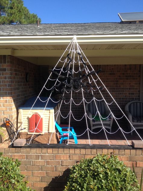 Spider web with clothesline and yarn Spiderweb Diy Decoration, Spider Web With Yarn, Yarn Spider Web, Halloween Yarn Spider Web, Diy Spider Web Yarn, Reusable Spider Web Diy, Fiesta Halloween, Spider Web Decoration, Jungle Decorations