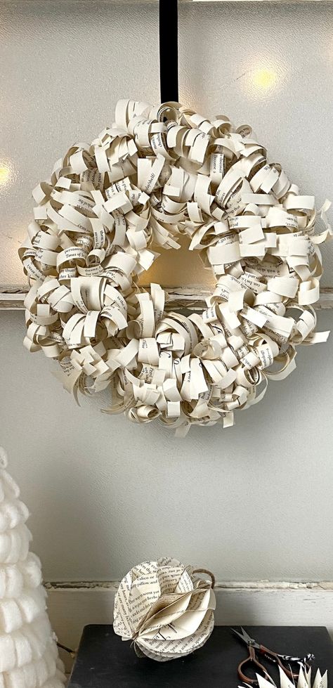 a paper wreath DIY made with book pages. Book Paper Pinecone Diy, Book Wreath Diy, Paper Crafts From Old Books, Recycled Paper Flowers, Christmas Wreaths Diy Paper, Book Page Crafts Diy, Homemade Wreaths Diy, Rolled Paper Wreath, Book Paper Crafts