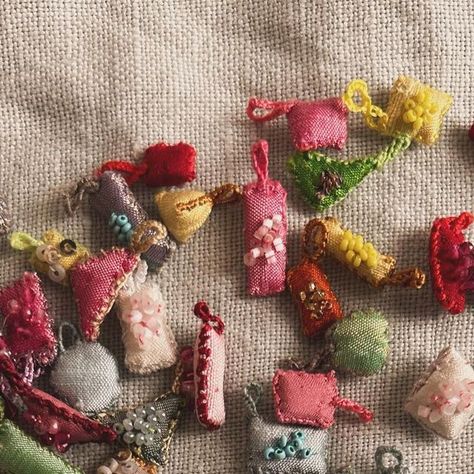 Antonia  Rossi on Instagram: "Tiny charms to carry with you at all times  #charms #embroidery #embroidered #love #protection #luckycharm #portebonheur #silk #collection" Tiny Charms, Embroidery Accessories, Vintage Sewing Notions, Visible Mending, Tiny Charm, Textile Jewelry, Slow Stitching, Fabric Beads, Bead Jewellery