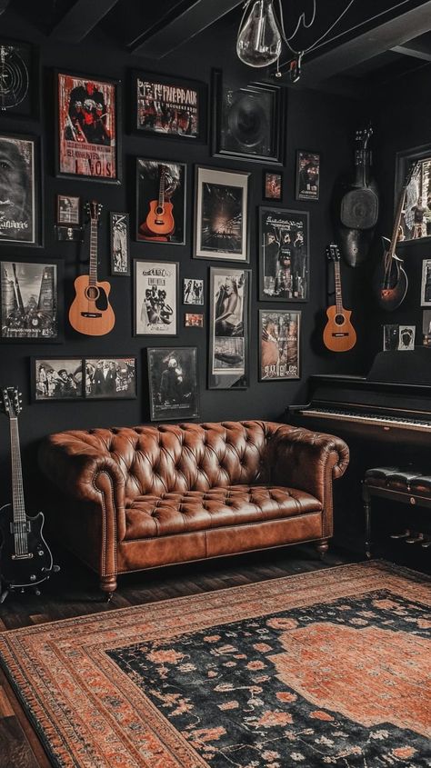 Cozy music room with black walls, leather couch, piano, guitars, and framed photos and records adorning the walls. Black Wall With Pictures, Music Basement Ideas, Music Studio Apartment Ideas, Record Lounge Room, Guitar Room Ideas Man Caves, Basement Music Studio Ideas, Rock And Roll Aesthetic Bedroom, Room With One Black Wall, Industrial Music Room