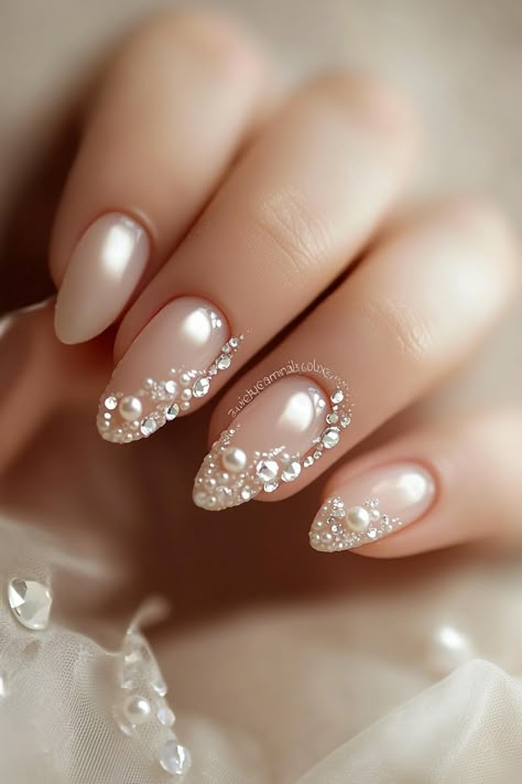 Wedding day manicure. French tips with pearl accents and small crystal details.  First impressions last a lifetime - and that’s why every detail matters on your big day, especially when it comes to your nails. Presenting 39 mix of timeless classics and trendy bridal wedding nail art designs that promise to make your ring exchange even more photogenic. Whether you're all about…  Read more: https://tastywed.com/generated-post-39-creative-bridal-wedding-nail-art-designs-and-tips/ White Wedding Nails With Rhinestones, Nail Art Designs With Pearls, Bridal Nails Wedding Pearl, Pearl Wedding Nails For Bride, Nail Designs Wedding Bridal, Wedding Pearl Nails, Shaadi Nails, Wedding Bride Nails Ideas, Pearl Bridal Nails