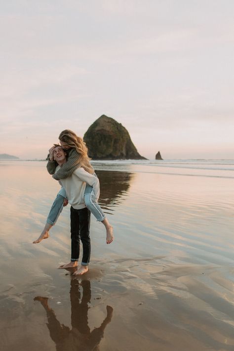 Couple in piggy back pose in front of haystack rock in Oregon. Canon Beach Oregon, Photoshoot Sunset, Canon Beach, Couples Beach Photography, Couple Beach Pictures, Oregon Beach, Beach Photo Session, Oregon Photography, Fall Beach