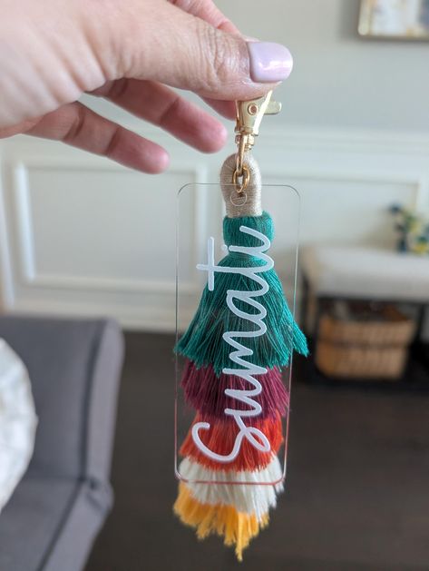 Add a touch of personalization to your bag or keys with our custom acrylic name tags! Featuring a sleek clear design, a vibrant tassel, and a name of your choice, these tags are perfect for gifting. Whether for bridesmaids, Mother's Day, teachers, students, or friends, this stylish accessory is both practical and thoughtful. Perfect for: Purses, backpacks, keys, luggage, and more! Great gift idea for any occasion. Size: 7.75"x 1.25" (including the Claw Clip) Tassel Size: 4"x 1.5" Clear Acrylic Name Tag Please reach out to us for bulk pricing. Acrylic Name Tags, Acrylic Keychains, The Claw, Claw Clip, Name Tag, Name Tags, Bag Tags, Stylish Accessories, You Bag