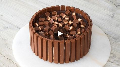 5.4M views · 19K reactions | No Bake Kitkat Cheesecake 😍 | No Bake Kitkat Cheesecake 😍

Throwing it back to this super delicious and tasty chocolatey KitKat cheesecake!
It’s so easy to make and it’s such a... | By Fitwaffle | What's up guys? Today we're
going to be making a KitKat cheesecake. First line your tin
with KitKats and set aside. Add crushed digesters and melted
butter to a bowl and mix until combined then scoop into the
tin and press down firmly. Pop this in the fridge for now. Add
double cream to a bowl and whisk to form stiff peaks. In
another bowl add cream cheese and icing sugar and whisk until
smooth then fold in the whipped cream. Scoop the mix onto your
base. Smoothen it out to the edges then refrigerate for at
least five hours. Pour hot cream over dark chocolate or
cho Kitkat Cheesecake, Group Dessert, Kids Party Treats, Double Cream, Blueberry Desserts, Throwing It Back, Inspirational Songs, Air Fryer Recipes Healthy, Icing Sugar