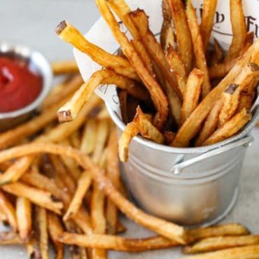 A small silver pale holding homemade French fries with a small bowl of ketchup nearby. Best Homemade French Fries, Home Made French Fries, Friend Fries, French Fries At Home, Perfect French Fries, Fries Recipes, Best French Fries, Homemade Fries, French Fries Recipe