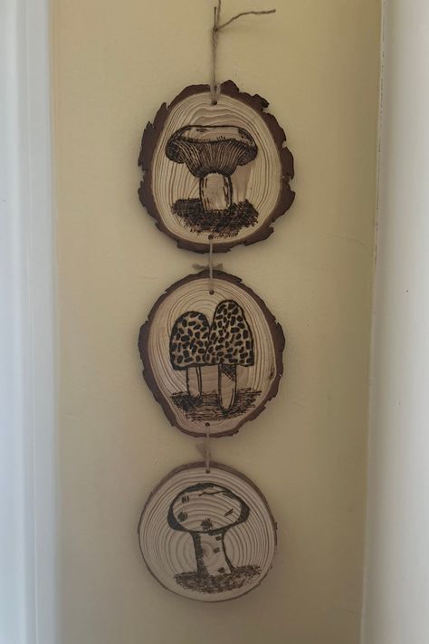 Bring a touch of nature into your home with this unique set of handcrafted mushroom wall art. Each piece features a different mushroom design, carefully wood burned onto natural wood slices. These rustic yet elegant pieces are perfect for adding a woodland charm to any room. Burning Wood Art, Log Art, Mushroom Wall Art, Burning Wood, Rustic Fall Decor, Wood Burning Crafts, Wood Burning Art, Mushroom Design, Wall Art Set Of 3