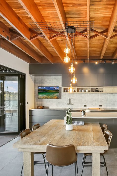 This fabulous kitchen is both stunning and very practical. The kitchen layout is simple with a big main kitchen counter and a good-sized island bench. This basic layout includes plenty of cabinetry for storage, a modern double sink, and wall-mounted tapware. This layout also connects with outdoor spaces and internal and external entertainment spaces. If you're looking for the very best in a luxury kitchen, start here. Light Fixtures For High Ceilings, Feng Shui Interior Design, Light Bulb Design, Cottage Style Interiors, Kitchen Lighting Design, Drop Ceiling, Cage Light, Vintage Light Bulbs, Fabulous Kitchens