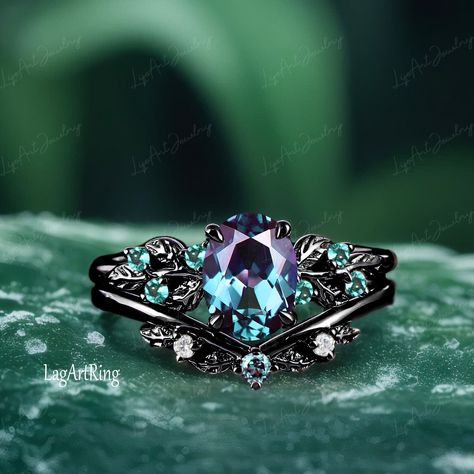 - Metal :The underneath metal is in Silver/ 10K/14K/18K white gold, coated with black rhodium Oval cut Alexandrite Engagement ring Black Gold Promise Ring Leaf Nature Inspired Ring Gothic Color changed Gemstone Bridal Ring sets Ring Details: - Theme:Romantic Wedding & Engagement - comfortable band - Stone:6*8mm lab alexandrite(Blue-green in daylight, purple-red in incandescent light.) Side stones: lab created emerald  - Total weight: 0.09 ctw (High Quality) - Color: D-F - Clarity: VVS1 - ring ba Magical Engagement Rings, Teal Sapphire Engagement Ring, Engagement Ring Black, Gold Promise Ring, Black Gold Ring, Black Engagement Ring, Nature Inspired Rings, Cute Engagement Rings, Gold Promise Rings