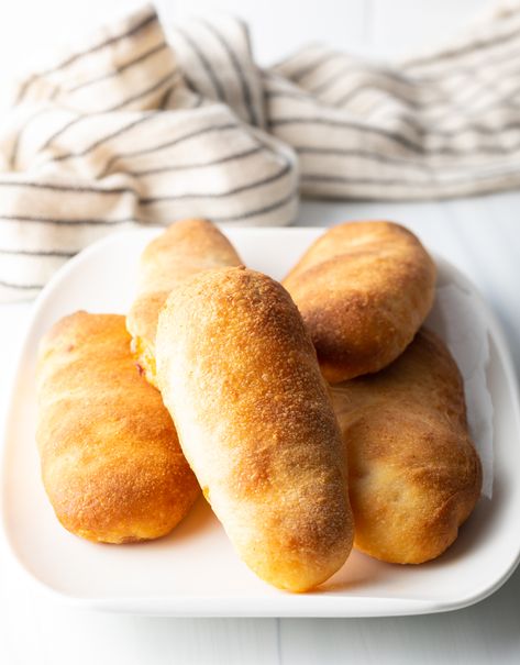 This classic West Virginia Pepperoni Rolls recipe includes flavorful slices of pepperoni and gooey mozzarella cheese, baked inside soft homemade pizza dough. Like a homemade hot pocket but WAY better :) | A Spicy Perspective Pepperoni Roll Dough Recipe, Peperoni Rolls Homemade, Sourdough Pepperoni Rolls, Wv Pepperoni Rolls Recipe, West Virginia Pepperoni Rolls Recipe, West Virginia Pepperoni Rolls, Easy Pepperoni Rolls, Classic Pizza Dough Recipe, Homemade Pepperoni Rolls