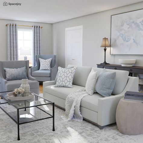 This is a calm & composed living room with coastal vibes. A super comfy sofa is paired with different kinds of armchairs in shades of blue. We see coastal elements in the decor & artworks. The dark wooden tone of the furniture enhances the blues and neutrals. The Presidio sofa is a vintage classic- layered with textured & printed blue, white throws, and cushions, adding to the coastal theme & add comfort. Like this? Check out the full design by our online interior designers at Spacejoy. Gray Blue Cream Living Room, Light Blue And Black Living Room, Blue And Cream Living Room Ideas, Grey And Light Blue Living Room, Living Room Decor Blue And Gray, Blue Grey White Living Room, Light Blue And Grey Living Room, Grey Blue Living Room Ideas, Neutral Living Room With Blue Accents