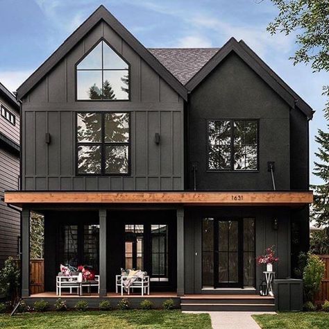 Delightful dark modern two story farmhouse with just a hint of contrast in the cedar beam. Large black windows and dutch doors bring the outdoors indoor and create an inviting family home. House by Trickle Creek Custom Homes. #downleahslane #blackhouse #blackhome #darkexterior #darkhouse #twostory #blackwindows #cedar #exteriorideas #exteriordesign #dreamhome #boardandbatten Dark Exterior House Colors, Dark Exterior House, Black Houses, Dark House, Casa Country, Casas The Sims 4, Modern Farmhouse Exterior, Casa Exterior, Black House Exterior