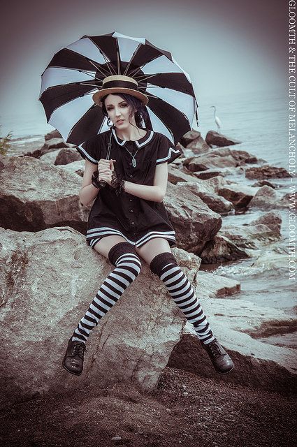 Gloomth Victorian bathing costume, vintage swimsuit at the seaside. Waves and water crashing against the rocks. Black and white striped parasol and over the knee socks Goth Bathing Suit, Goth Swimwear, Goth Swimsuit, Goth Beach, Canada Living, Dark Beauty Fashion, Circus Vintage, Carnival Fashion, Swimsuit Vintage